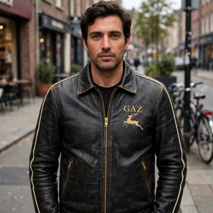 Person wearing the GAZ Leather Jacket outdoors, front-facing, showing gold 'gaz' wordmark with leaping deer emblem embroidered on the left chest