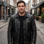 Man wearing the Lagonda Leather Jacket outdoors, front-facing, showing the heritage cruiser jacket and chest embroidery