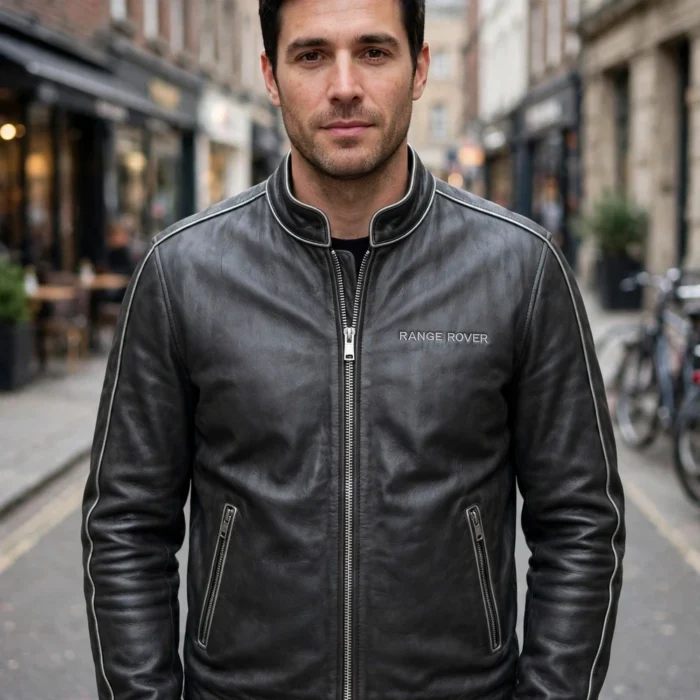 Man wearing the Range Rover Leather Jacket outdoors, front-facing, showing the luxury cruiser jacket and chest embroidery