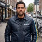 Model wearing the Volvo Leather Jacket, dark navy blue with Swedish blue and yellow accent stripes rally racer jacket